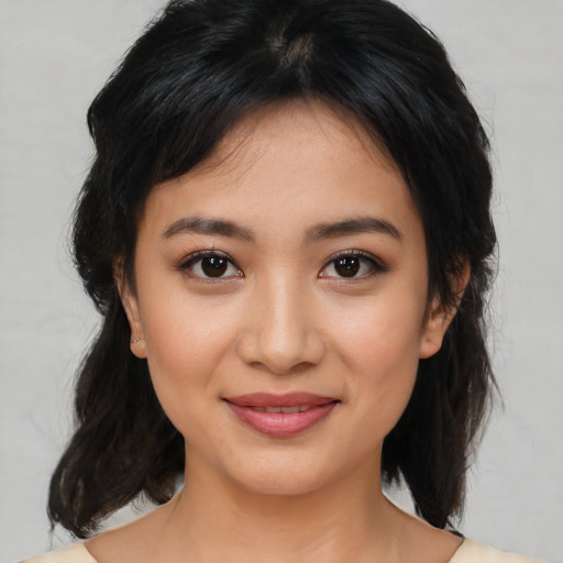 Joyful latino young-adult female with medium  brown hair and brown eyes