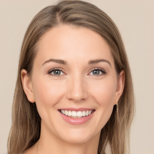 Joyful white young-adult female with long  brown hair and grey eyes