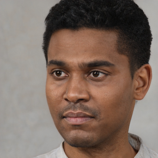 Neutral latino young-adult male with short  black hair and brown eyes