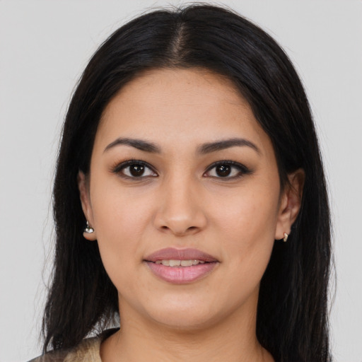 Joyful latino young-adult female with long  brown hair and brown eyes