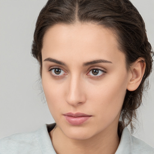 Neutral white young-adult female with medium  brown hair and brown eyes