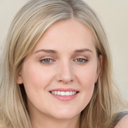 Joyful white young-adult female with long  brown hair and blue eyes