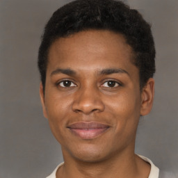 Joyful black young-adult male with short  brown hair and brown eyes