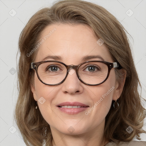 Joyful white adult female with medium  brown hair and blue eyes