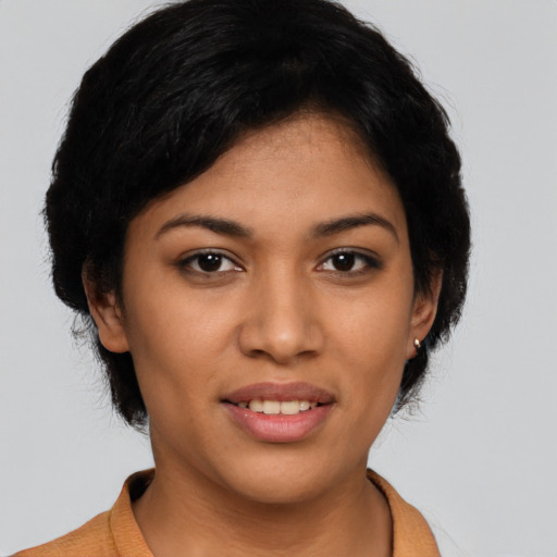 Joyful latino young-adult female with short  black hair and brown eyes