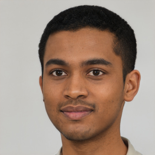 Joyful black young-adult male with short  black hair and brown eyes