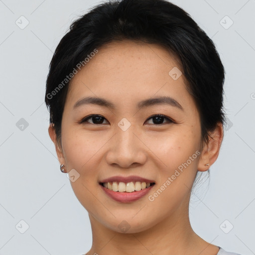 Joyful asian young-adult female with short  brown hair and brown eyes