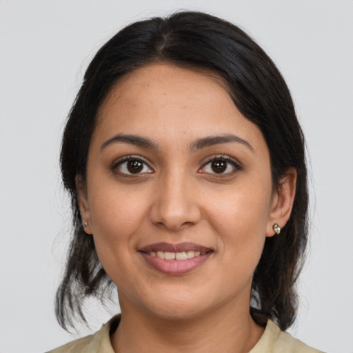 Joyful latino young-adult female with medium  brown hair and brown eyes