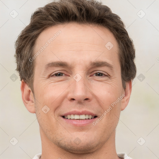 Joyful white adult male with short  brown hair and grey eyes