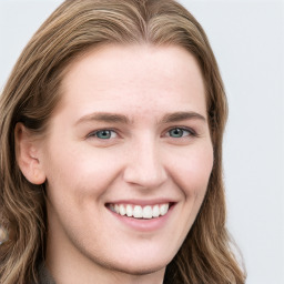 Joyful white young-adult female with long  brown hair and blue eyes