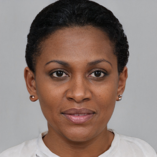 Joyful black young-adult female with short  brown hair and brown eyes