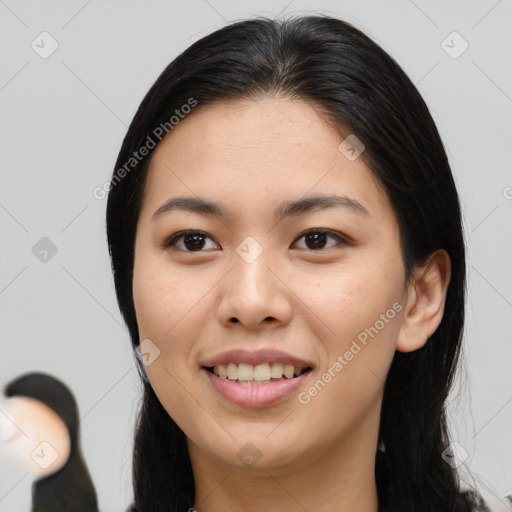 Joyful asian young-adult female with long  brown hair and brown eyes