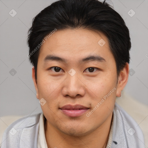 Joyful asian young-adult male with short  brown hair and brown eyes