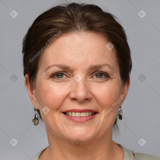 Joyful white adult female with medium  brown hair and grey eyes