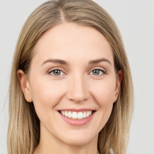 Joyful white young-adult female with long  brown hair and grey eyes