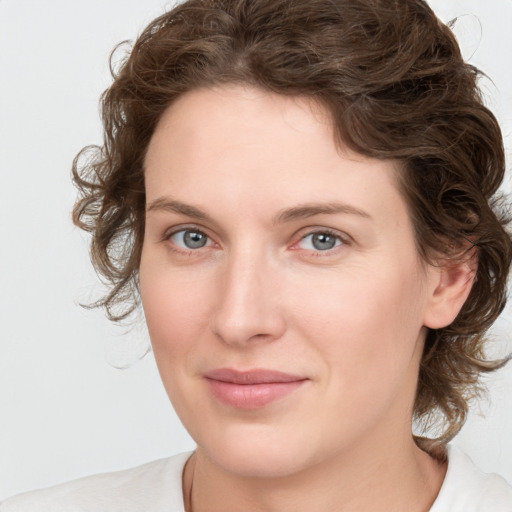 Joyful white young-adult female with medium  brown hair and green eyes