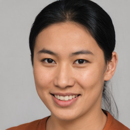 Joyful asian young-adult female with medium  brown hair and brown eyes