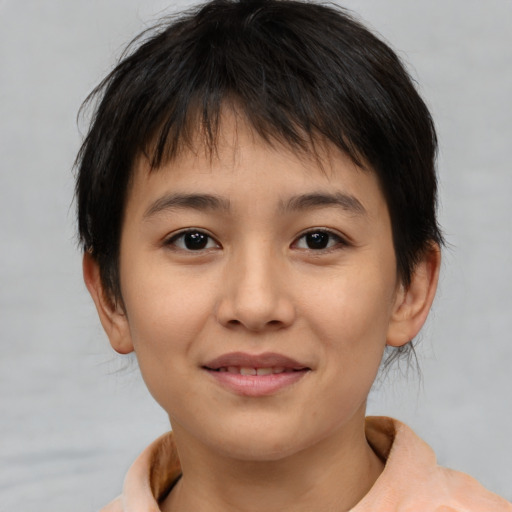 Joyful asian child female with medium  brown hair and brown eyes