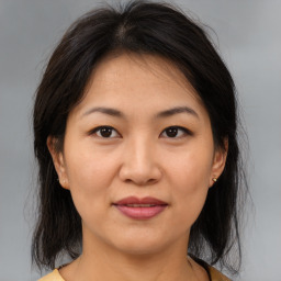 Joyful asian young-adult female with medium  brown hair and brown eyes