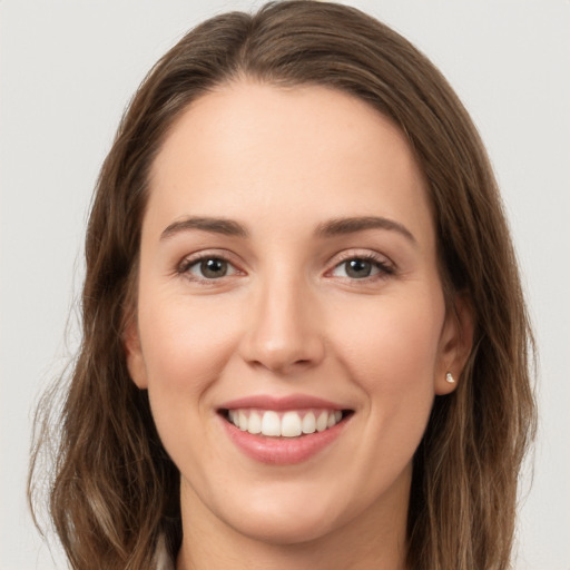 Joyful white young-adult female with long  brown hair and grey eyes