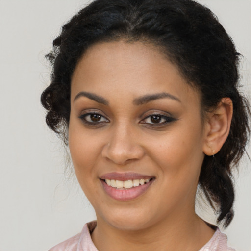 Joyful latino young-adult female with medium  brown hair and brown eyes