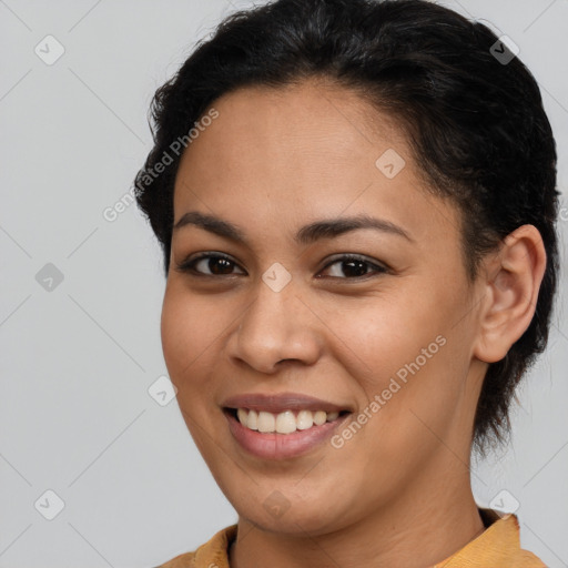 Joyful latino young-adult female with short  brown hair and brown eyes