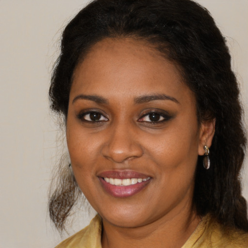 Joyful black young-adult female with medium  brown hair and brown eyes