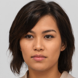 Neutral asian young-adult female with medium  brown hair and brown eyes