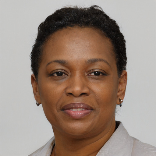 Joyful black adult female with short  brown hair and brown eyes
