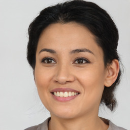 Joyful latino young-adult female with medium  brown hair and brown eyes