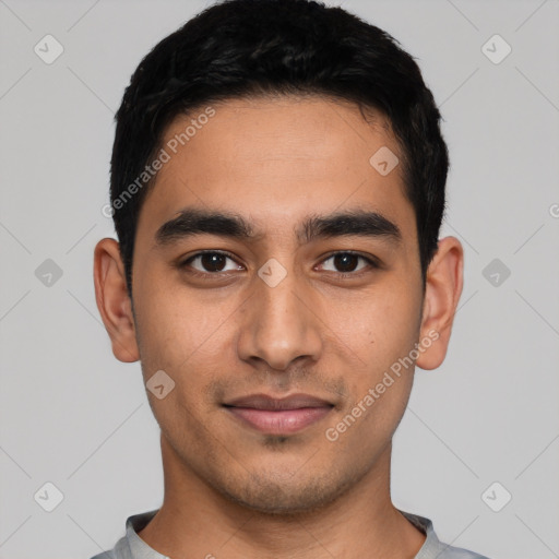 Joyful latino young-adult male with short  black hair and brown eyes