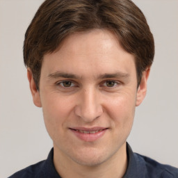 Joyful white adult male with short  brown hair and grey eyes