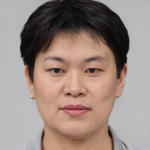 Joyful asian adult female with short  brown hair and brown eyes