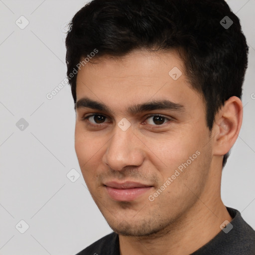 Joyful white young-adult male with short  black hair and brown eyes