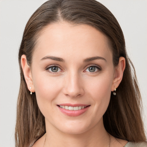 Joyful white young-adult female with long  brown hair and grey eyes