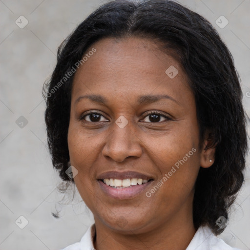 Joyful latino adult female with medium  brown hair and brown eyes