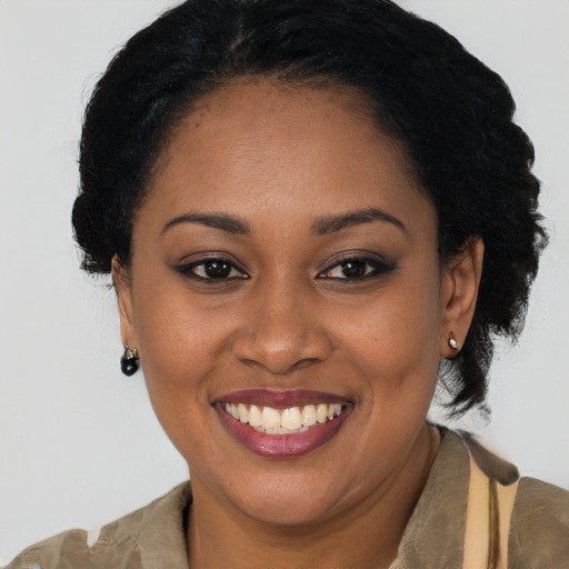 Joyful black young-adult female with short  brown hair and brown eyes