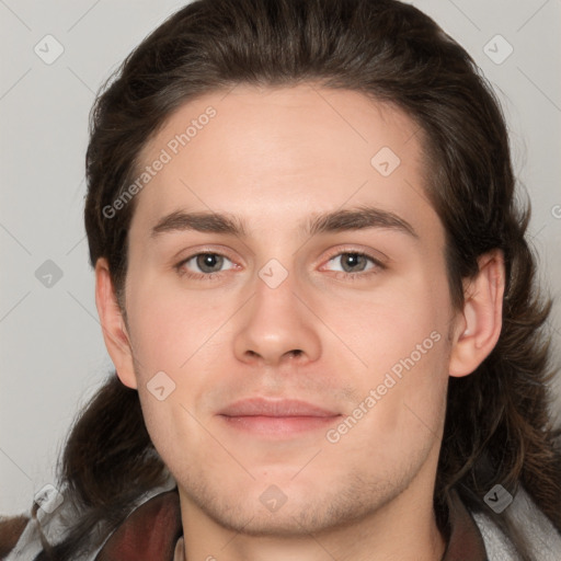 Joyful white young-adult male with medium  brown hair and brown eyes