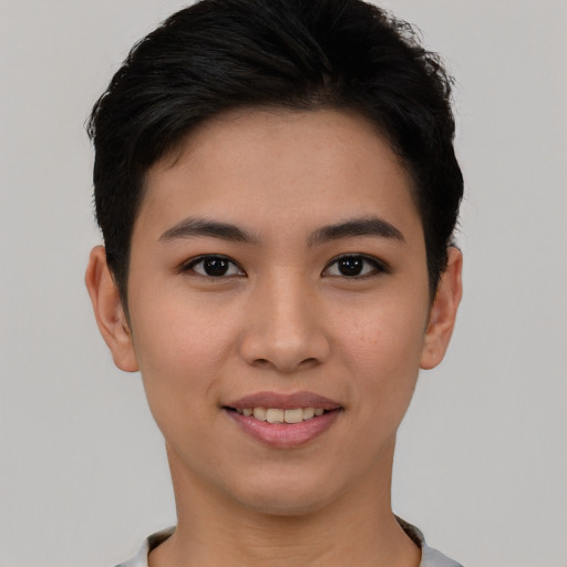 Joyful asian young-adult female with short  black hair and brown eyes