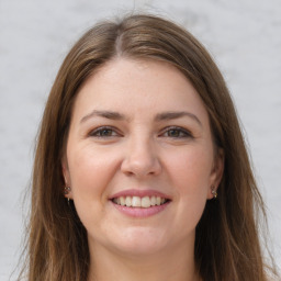 Joyful white young-adult female with long  brown hair and grey eyes