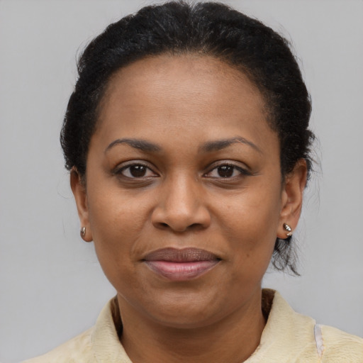 Joyful latino adult female with medium  brown hair and brown eyes