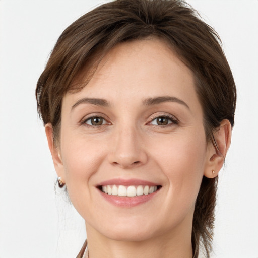 Joyful white young-adult female with medium  brown hair and grey eyes