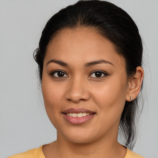 Joyful latino young-adult female with medium  brown hair and brown eyes