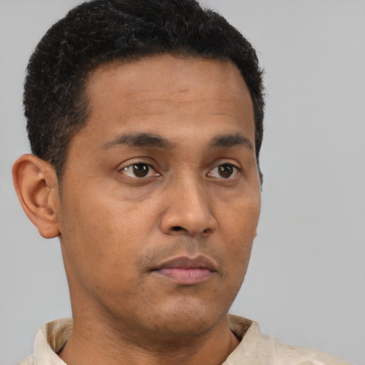 Neutral latino young-adult male with short  brown hair and brown eyes