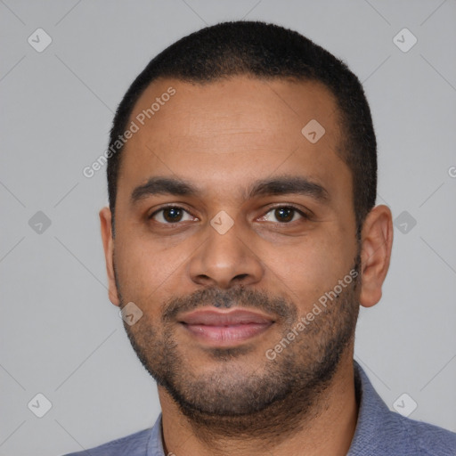 Joyful latino young-adult male with short  black hair and brown eyes