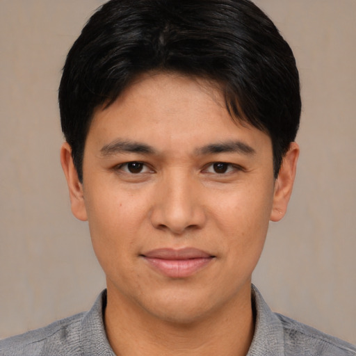 Joyful asian young-adult male with short  black hair and brown eyes