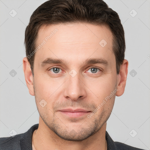 Joyful white young-adult male with short  brown hair and grey eyes