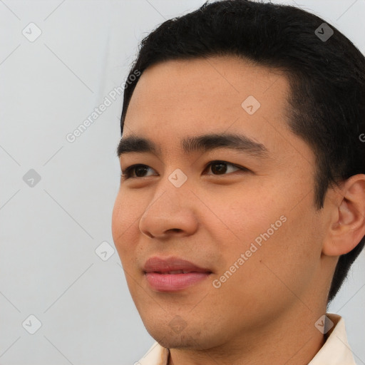 Joyful asian young-adult male with short  black hair and brown eyes