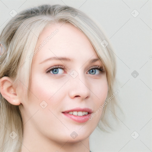 Joyful white young-adult female with long  blond hair and blue eyes