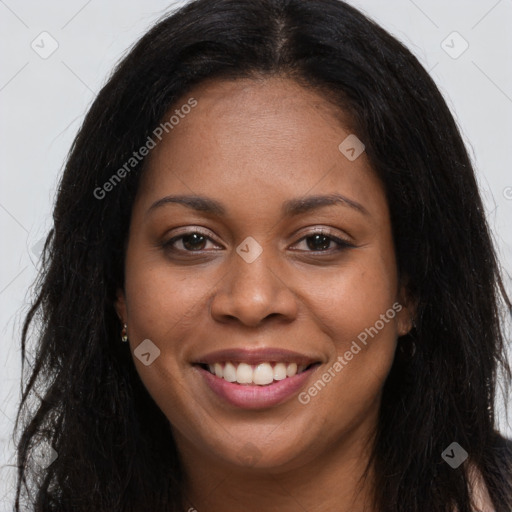 Joyful black young-adult female with long  brown hair and brown eyes